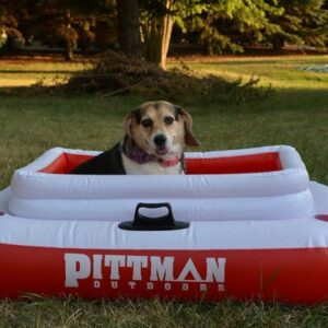 Lifestyle photo of Pittman PPI-ICELRG inflatable ice chest on grass with dog sitting inside