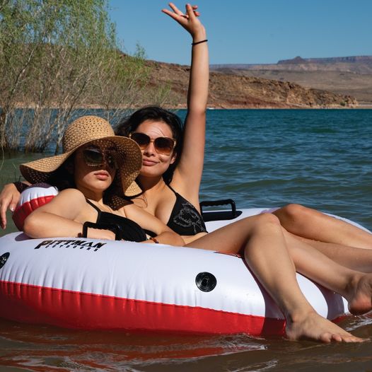 Lifestyle photo of Pittman PPI-RD2 inflatable river drifter on water with 2 female models